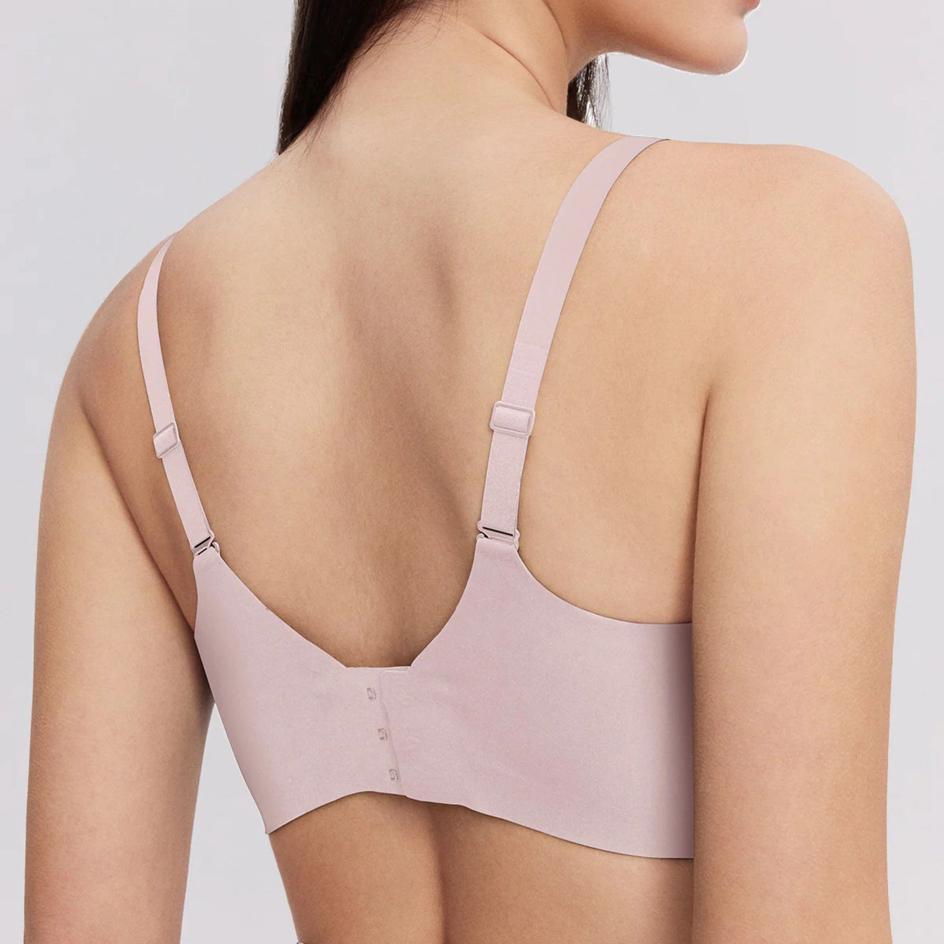The woman wears a Side Support Back Hook Bra Pink with ultra Thin Back Hooks.