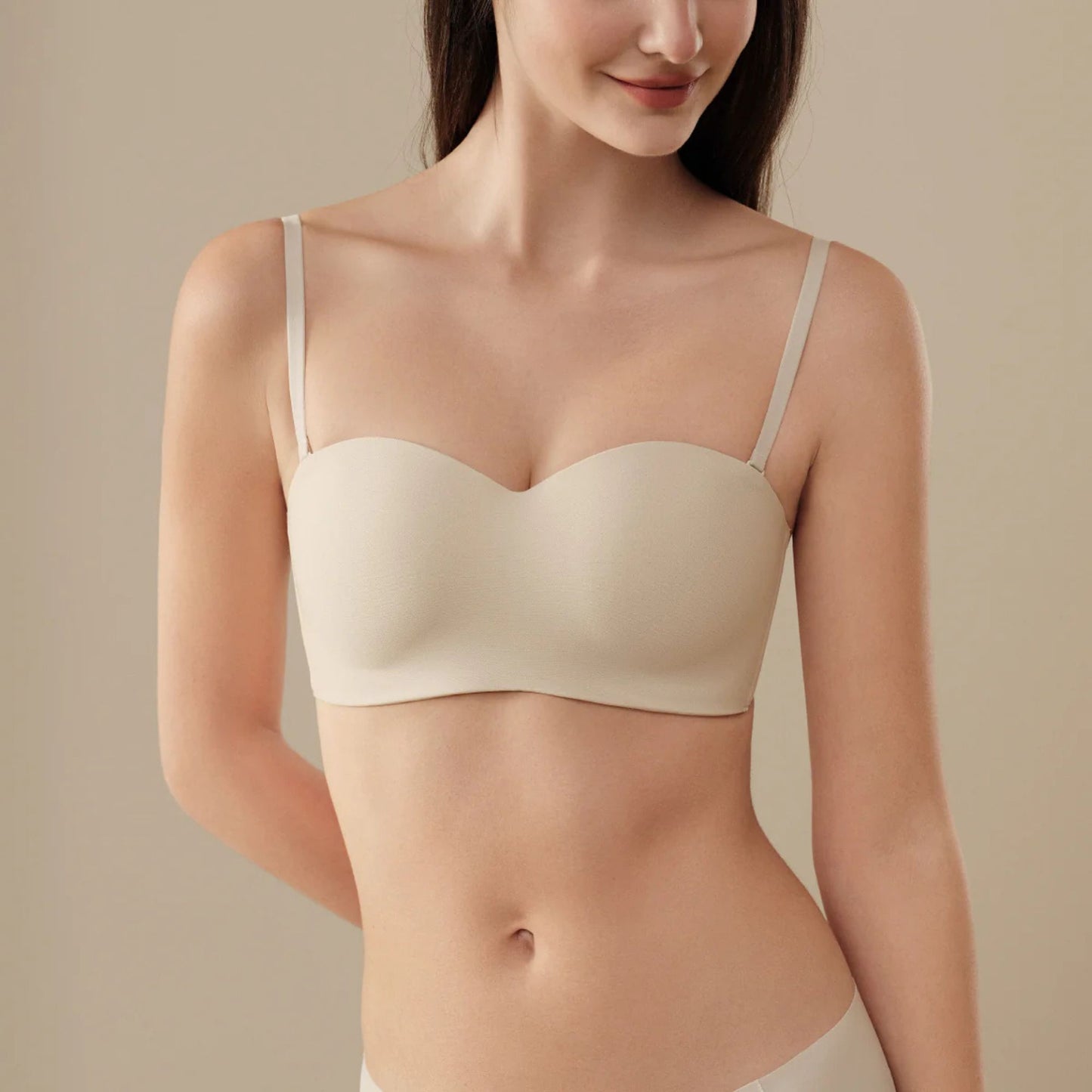 Woman wearing a beige UBRAS Intense Convertible Bandeau bra